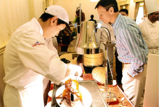 Tom Staggs samples the excellent Peking Roast Duck at Hong Kong Disneyland.