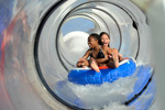 Riders aboard the AquaDuck water coaster