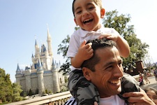  Chilean miner rescuer Roberto Cristian Rios is all smiles as he gives his son, Robert Alex Rios (age 4), a ride atop his shoulders in front of Cinderella Castle at the Walt Disney World Resort