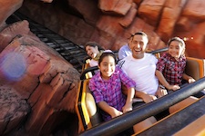 Chilean miner rescuer Roberto Cristian Rios (center) joins his twin daughters Elizabeth de los Angeles Rios (left, age 8) and Paz Alexandra Rios (right, age 8) for a ride aboard the Big Thunder Mountain Railroad attraction at the Walt Disney World Resort