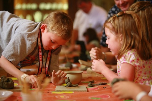 Young travelers can paint clay to make a special keepsake from their experience in Palermo
