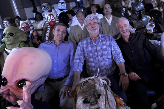 Walt Disney Co. president and CEO Bob Iger (left) 'Star Wars' creator George Lucas (center) and actor Anthony Daniels, who portrayed C-3PO in 'Star Wars' (right), pose with 'Star Wars' characters May 20, 2011 inside a 'Star Tours' ride vehicle at Disney's Hollywood Studios theme park in Lake Buena Vista, Fla. during grand opening ceremonies for 'Star Tours -- The Adventures Continue,' a new 3-D attraction based on the 'Star Wars' films. The attraction, which features more than 50 possible random ride experiences, opened May 20, 2011 at Walt Disney World in Florida and will open June 3, 2011 at Disneyland Resort in California. (David Roark, photographer)