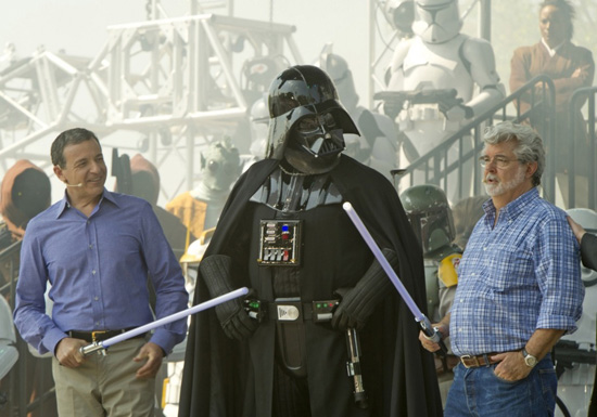 Walt Disney Co. president and CEO Bob Iger (left) and 'Star Wars' creator George Lucas (right) join 'Star Wars' villain Darth Vader (center) May 20, 2011 at Disney's Hollywood Studios theme park in Lake Buena Vista, Fla. during grand opening ceremonies for 'Star Tours -- The Adventures Continue,' a new 3-D attraction based on the 'Star Wars' films. The attraction, which features more than 50 possible random ride experiences, opened May 20, 2011 at Walt Disney World in Florida and will open June 3, 2011 at Disneyland Resort in California. (Kent Phillips, photographer)