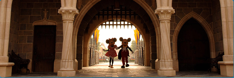 Mickey Mouse and Minnie Mouse Walk Under the Arch of Sleeping Beauty Castle at Disneyland Park