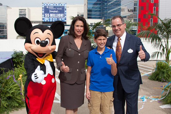 From left, Mickey Mouse, CHOC Children’s President and CEO Kim Cripe, 14-year-old CHOC patient Tommy Conforti and Disneyland Resort President George A. Kalogridis.