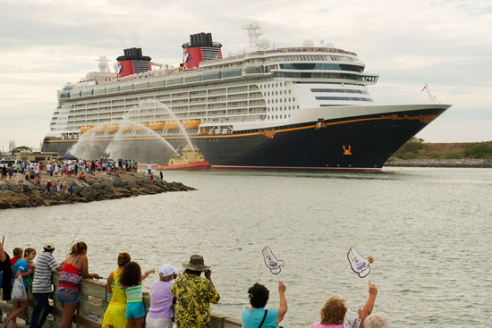 The Disney Fantasy sailing by approximately 4,500 spectators, who were waving Mickey hands along the shoreline.
