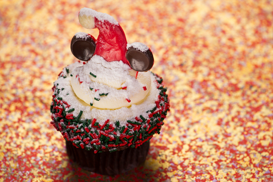 Gingerbread Cupcakes Topped with Cream Cheese Icing, Holiday Sprinkles and a Festive Minnie Mouse Hat, Available at Disney's Hollywood Studios Gingerbread Cupcakes Topped with Cream Cheese Icing, Holiday Sprinkles and a Festive Minnie Mouse Hat, Available at Disney's Hollywood Studios