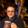 Actor Andy Garcia poses December 5, 2012 with a mug of ‘LeFou’s Brew’ at Gaston’s Tavern in New Fantasyland at the Magic Kingdom theme park in Lake Buena Vista, Fla. LeFou’s Brew is a non-alcoholic, no-sugar added frozen apple juice with a hint of toasted marshmallow, topped with all-natural passion fruit-mango foam.