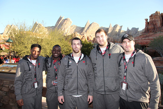 Players from the Wisconsin Badgers pose at Cars Land in Disney California Adventure park Players from the Wisconsin Badgers pose at Cars Land in Disney California Adventure park