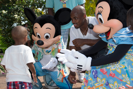 NFL Player Adrian Peterson of the Minnesota Vikings with Mickey and Minnie Mouse at Aulani, a Disney Resort & Spa for the Aulani Pro Bowl Reception