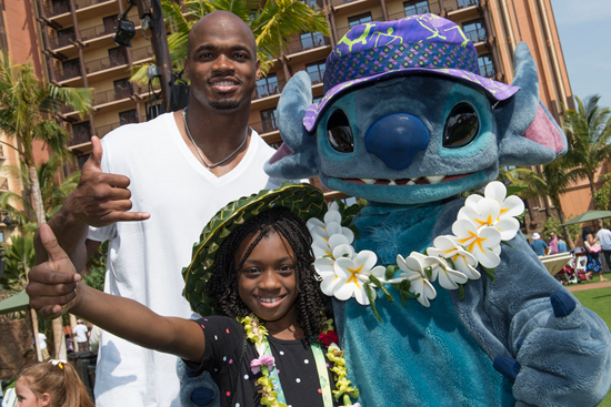 NFL Player Adrian Peterson of the Minnesota Vikings with Stitch at Aulani, a Disney Resort & Spa for the Aulani Pro Bowl Reception