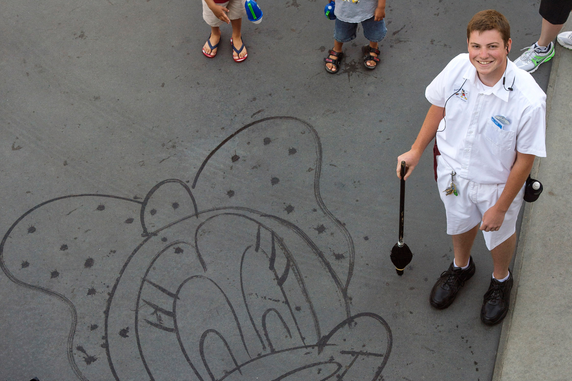 Hayes is One of 15 or so Cast Members Who Has Learned to ‘Paint’ Mickey, Minnie and Other Classic Disney Characters Using Nothing More Than His Broom and Water